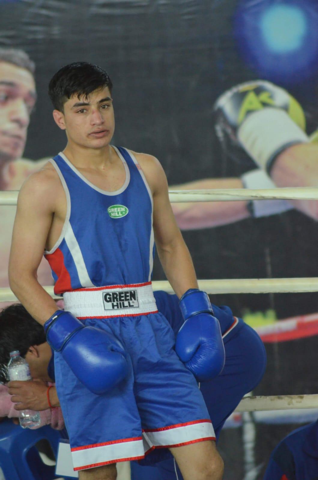 Boxer resting on the ropes between rounds