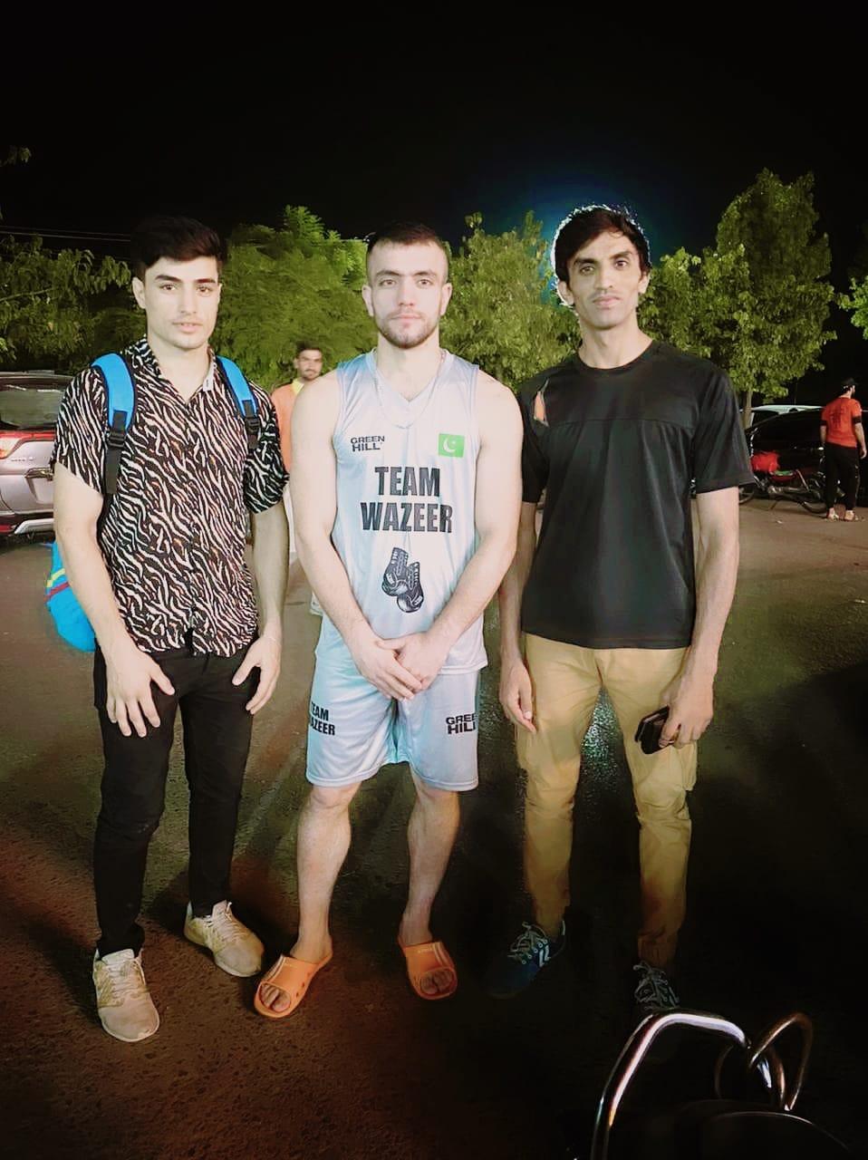 Coaches with a Team Wazeer boxer after a night of fights