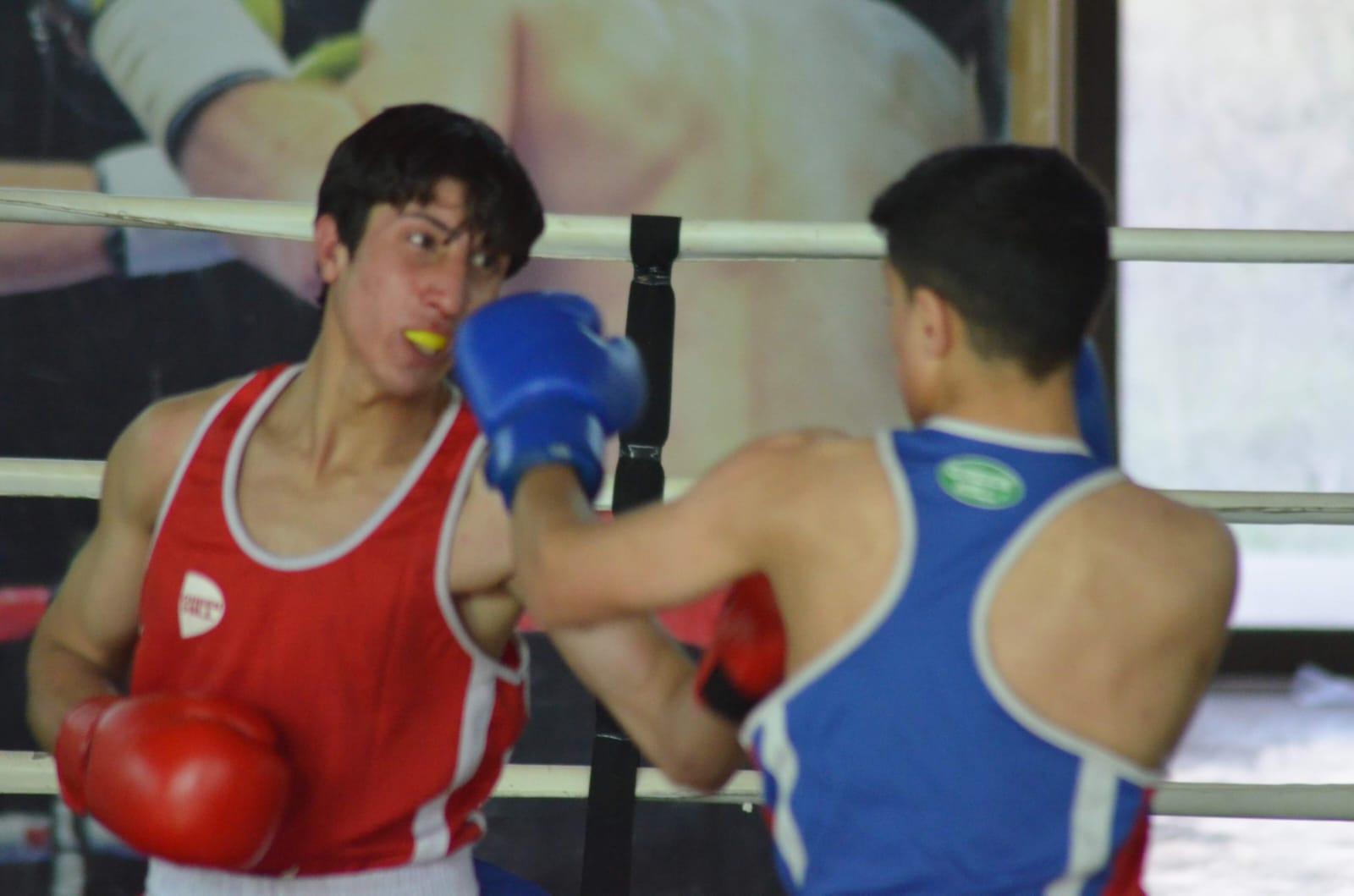 Two boxers exchanging punches in the ring during a bout