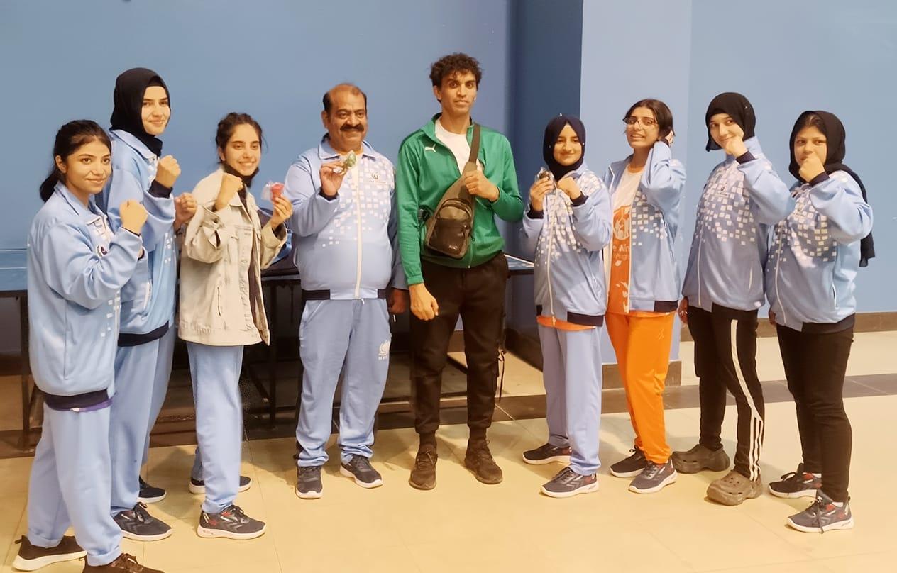 Women's boxing squad with their coaches and medals after a competition