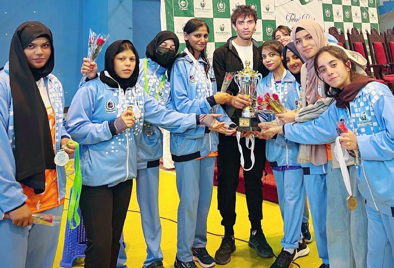 Women's boxing squad holding the winners' trophy at a Prime Minister's Youth Programme event